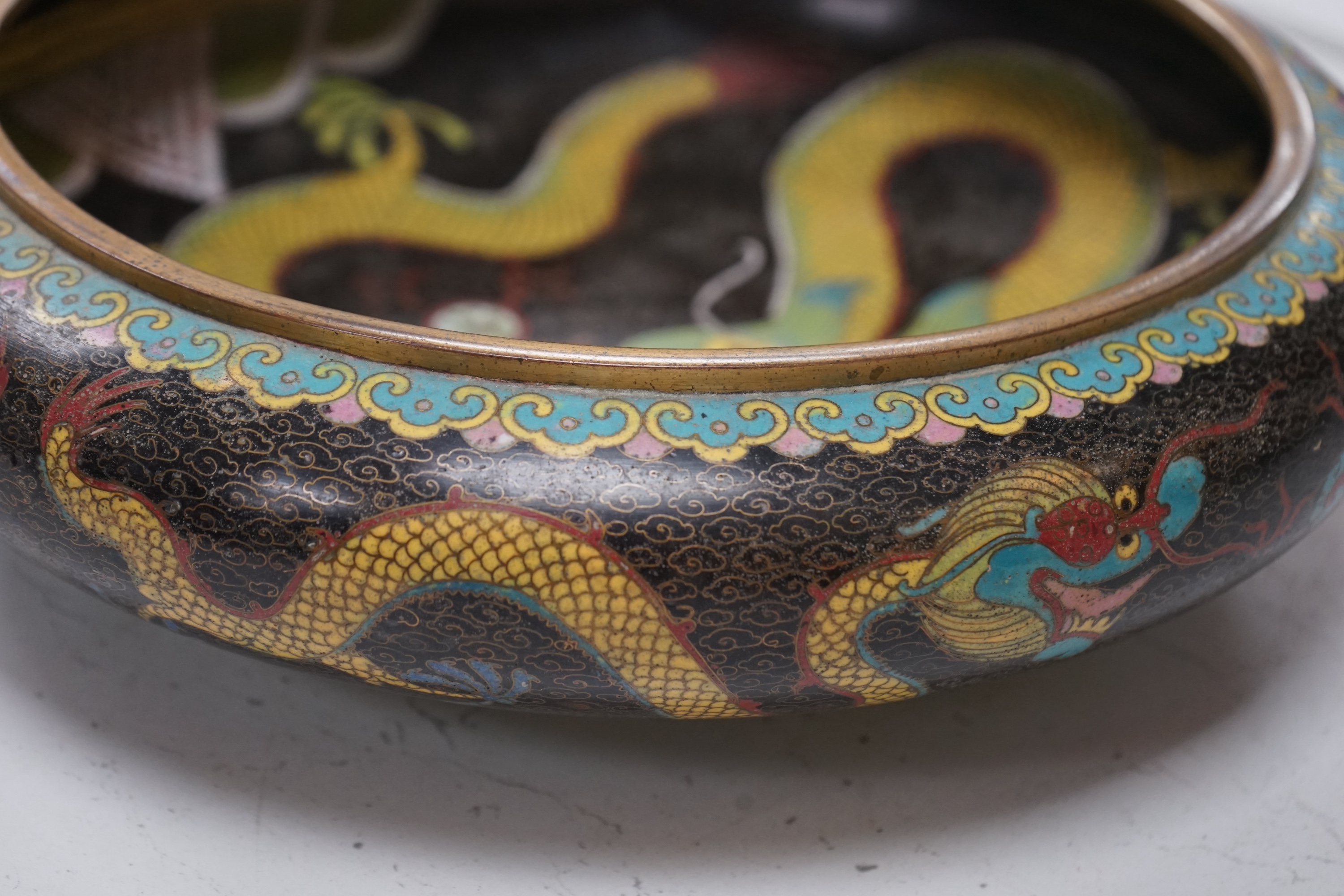 A pair of early 20th century Chinese cloisonné enamel ‘dragon’ bowls, 30cm diameter. Condition - fair to good